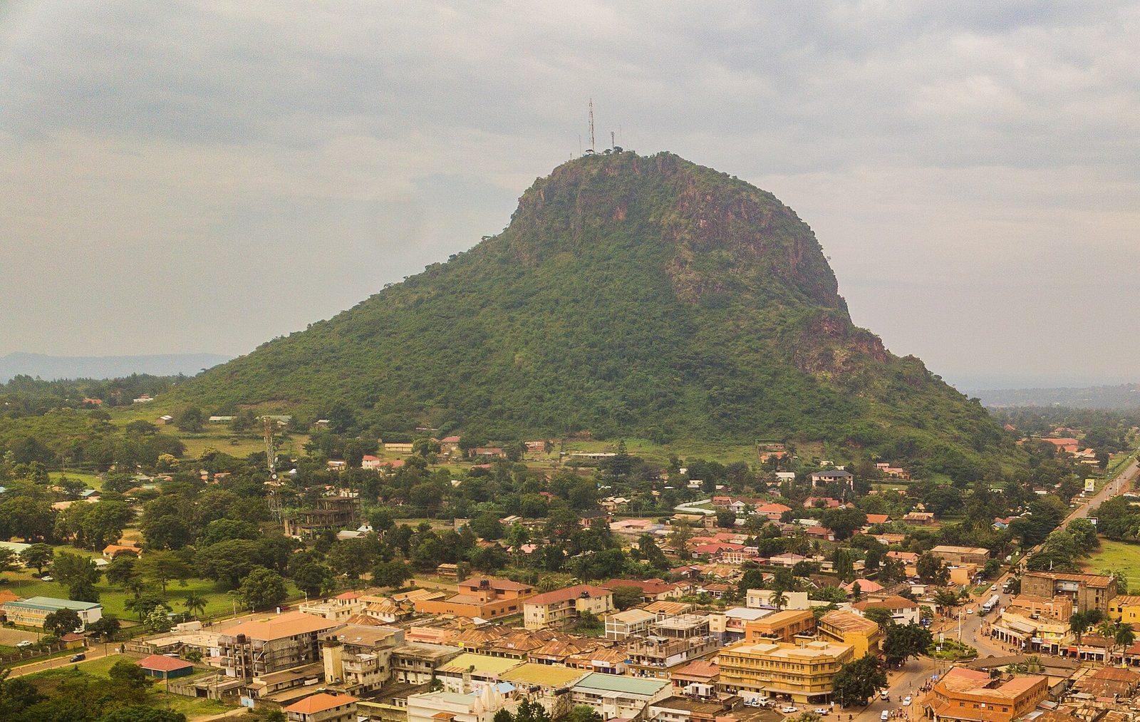 Tororo Rock — the green-flanked volcanic plug with masts on its summit — rising directly